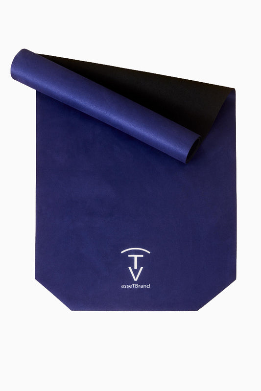 Rolled navy blue non-slip yoga mat with soft suede-style microfiber top and natural rubber base