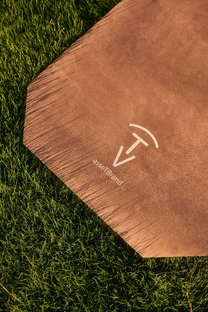 Close-up of camel machine-washable yoga mat with soft suede microfiber surface on grass