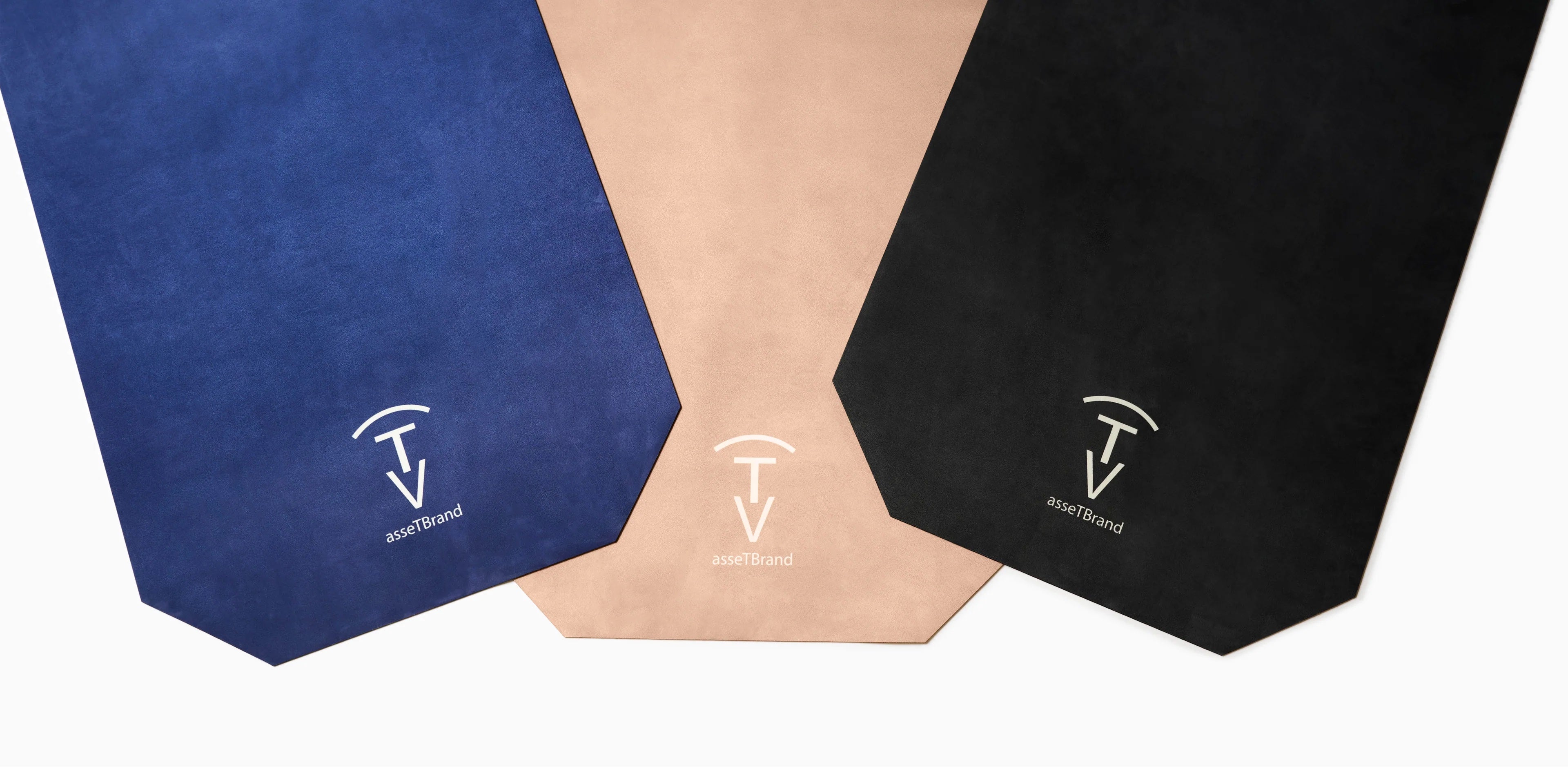 machine-washable yoga mats in blue, beige, and black with The Asset Brand logo